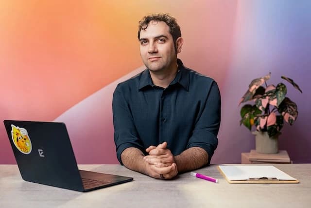 Course instructor at desk with laptop